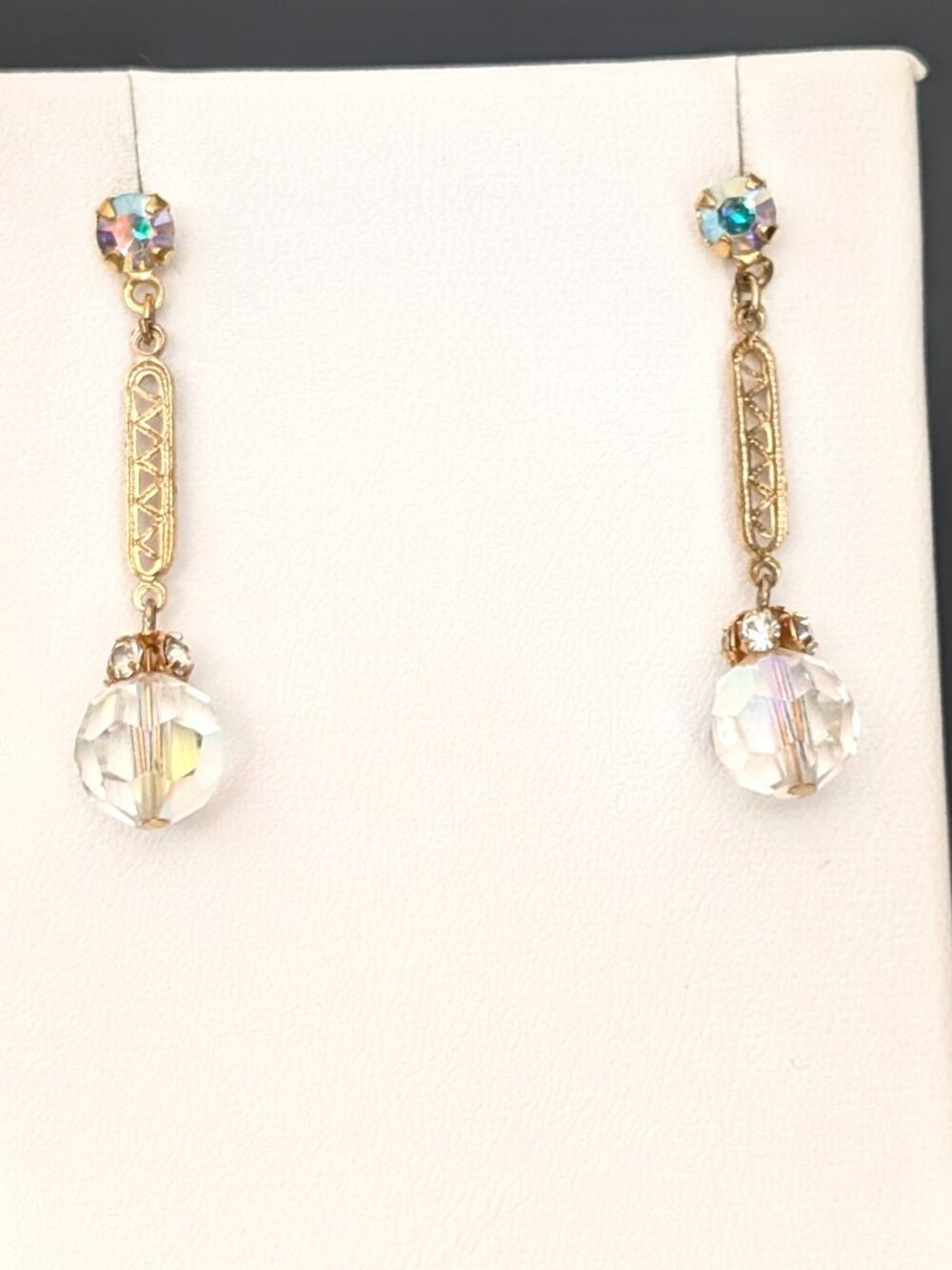 Gold tone dangle earrings with AB and clear beads